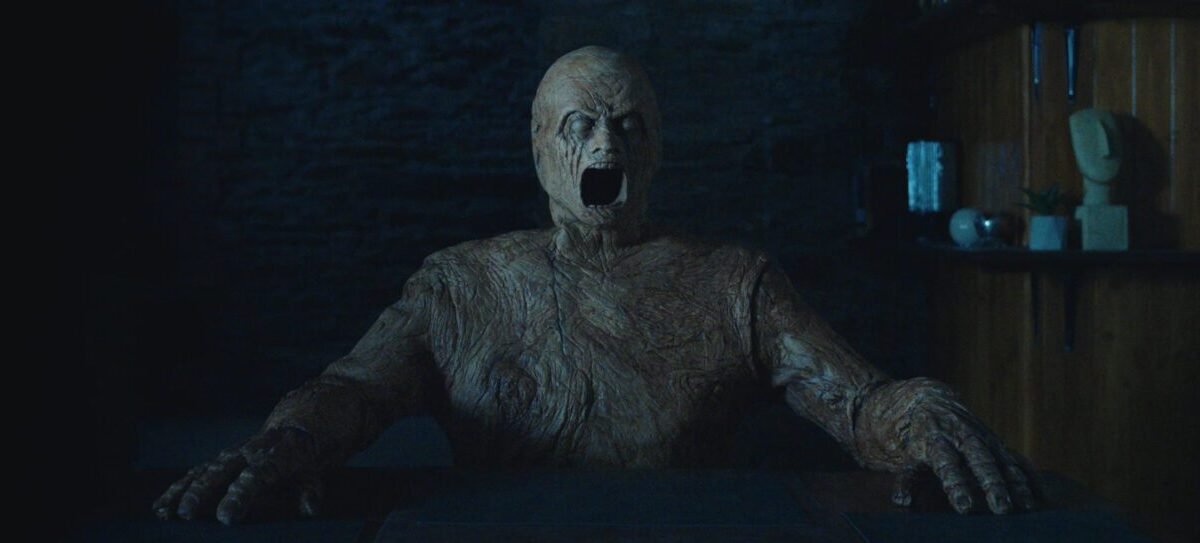 A wooden figure with it's mouth open
