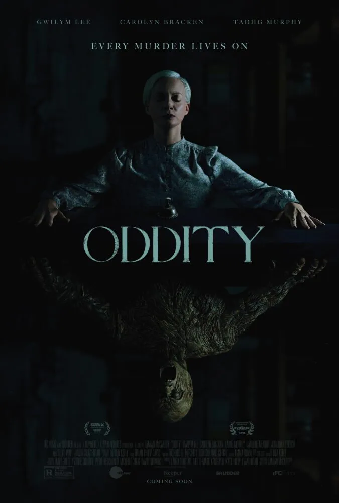 The poster for Oddity shows a woman outstretching her hands on a table in a mirrored image of a wooden figure doing the same beneath her.