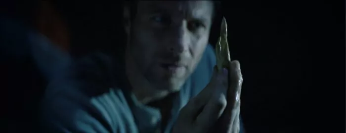 A man looking at a weird bone