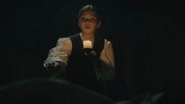 A kid holding a candle