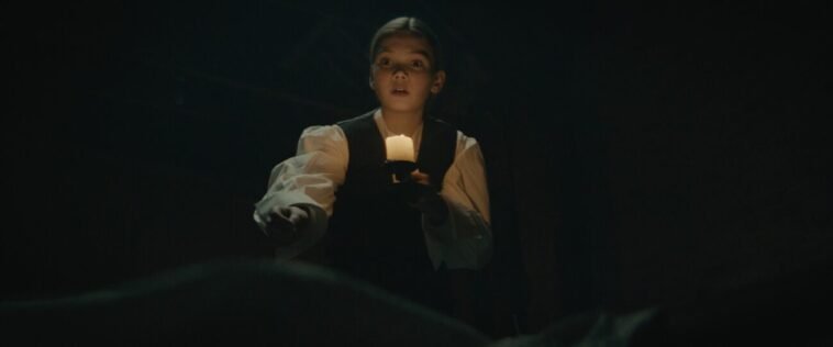 A kid holding a candle