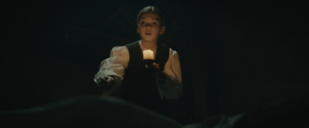 A kid holding a candle