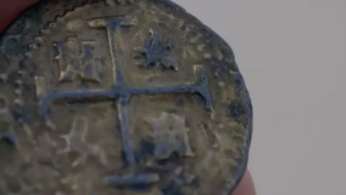 A closeup of one of the Spanish coins 