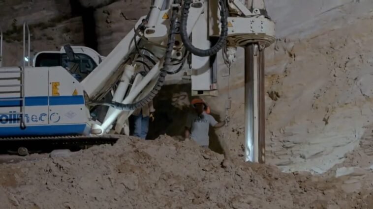 A team uses a rathole rig to create a new hole in the mountainside