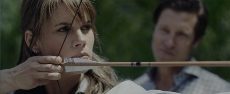 A woman shooting a bow and arrow