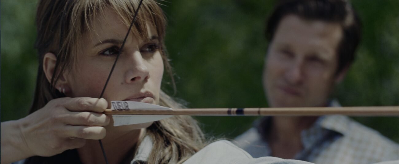 A woman shooting a bow and arrow