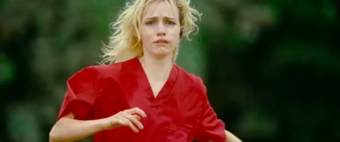 A woman running and looking scared