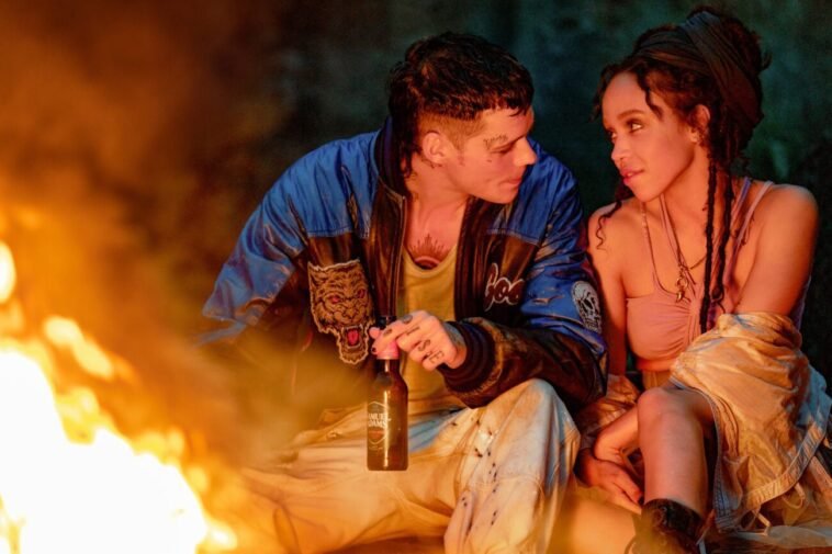 A man and a woman by a fire