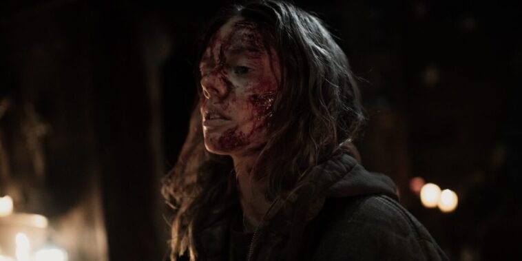 A woman with a bloodied face projects strength.
