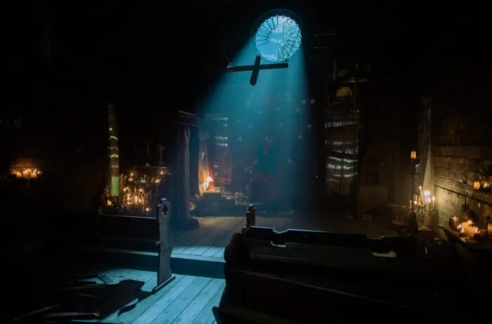 The moonlight creeps into a barn converted into a church.