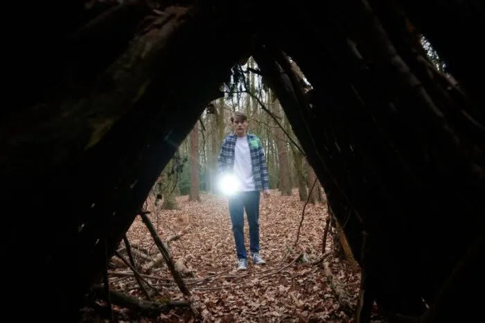 A man looking into an outdoor structure