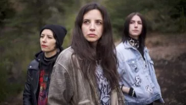 Three young women standing outdoors