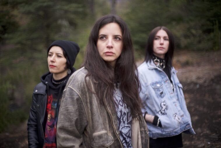 Three young women standing outdoors