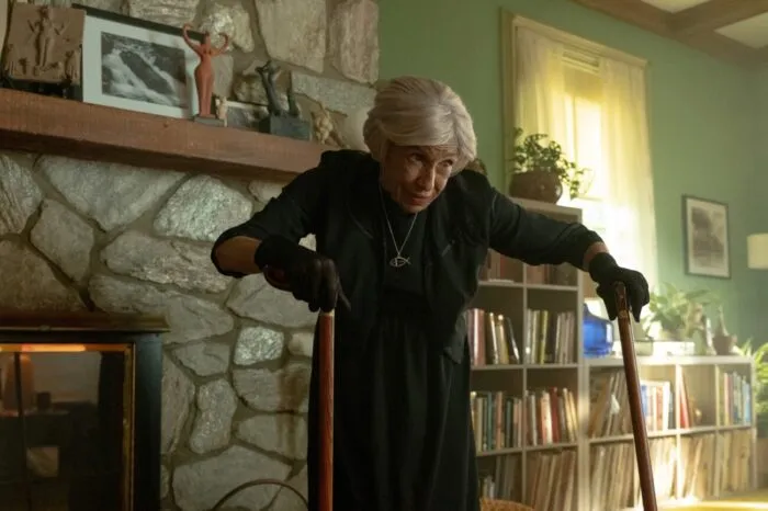 An old woman walking with canes