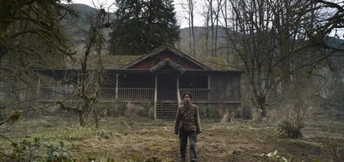 A woman standing in front of a house