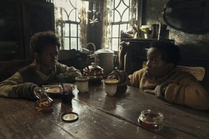 Two kids sitting at a table together