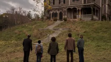 People walking up to a big house