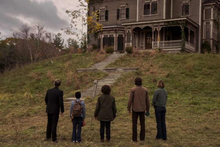 People walking up to a big house