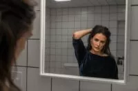 A woman looking in the mirror
