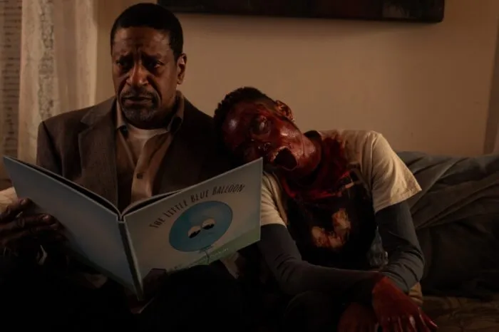 A zombie-looking woman leaning on her father