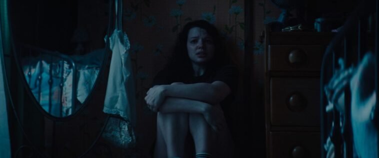 A woman cowering in fear