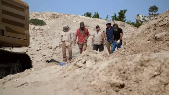 Duane Ollinger, Eric Drummond, Chad Ollinger, Charlie Boy, and Jamie Dube walk toward the Water Pit