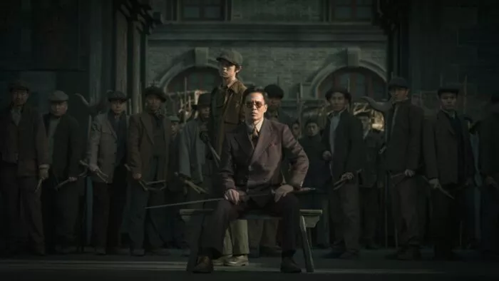 A man sitting in front of a crowd