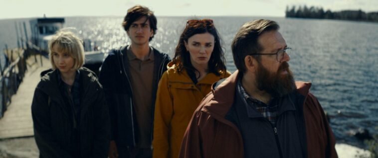 four people standing on a windy dock in GET AWAY