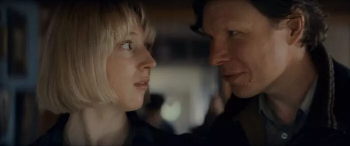 A woman staring into the eyes of a man standing uncomfortably close in GET AWAY
