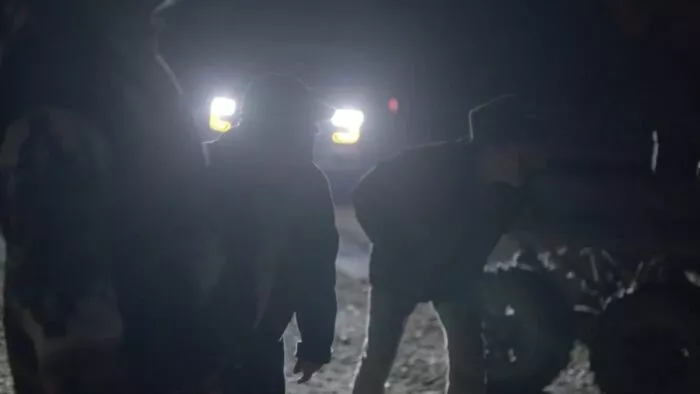 Duane, Jamie, and Eric look onward at the trespassers 