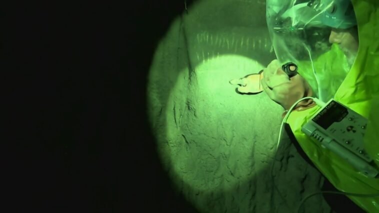 Eric points at the tally marks in the tunnels