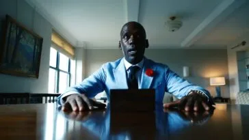 A suited man sitting at a desk