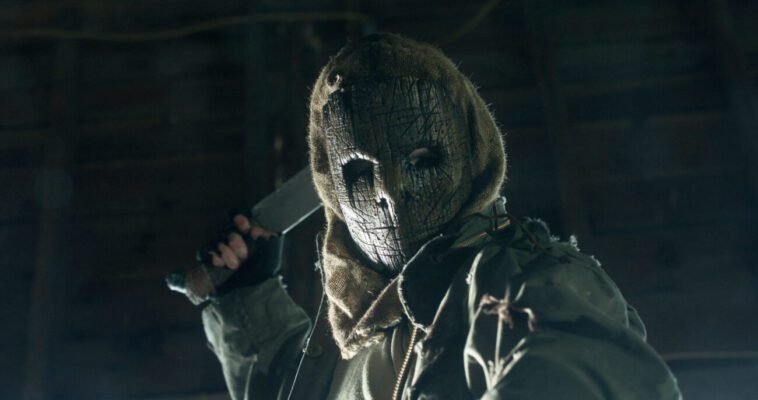 A masked killer weilds a machette in BLOODY AXE WOUND