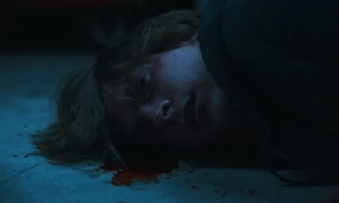 A young man laying in a pool of plood.