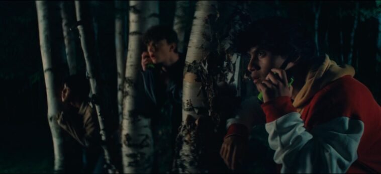 Three young men hide in the trees using walkie talkies in Tales From the Void's Fixed Frequency.