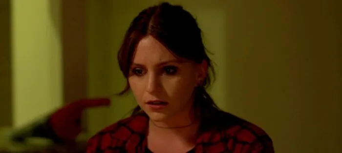 A woman is looking down at something intensely.