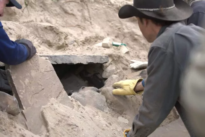 Josh Feldman looks into the stone altar in MYSTERY AT BLIND FROG RANCH