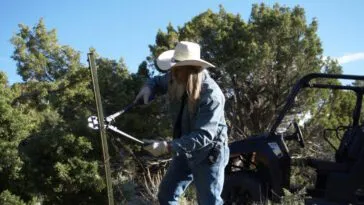 Charlie Snider cuts through barbed wire.