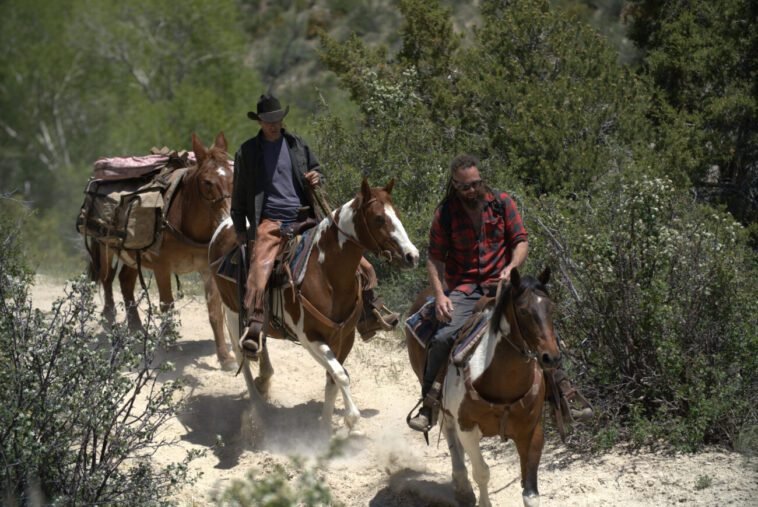 Chad Ollinger and Josh Feldman ride their horses up the trail.