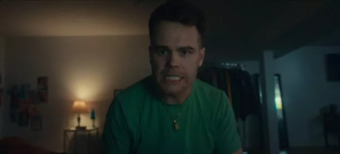 A man stares angrily into the camera