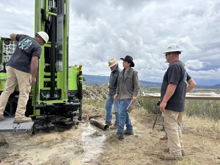 On the top of the Bead Site, Duane Ollinger and Josh Feldman talk to Sonic Drill operator Denzel Roberts about the burst of water that just shot up from deep inside hillside