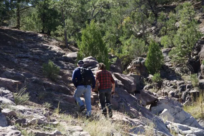 Out near Lake Anaconda, James Keenan and Chad Ollinger scramble up a hill to head back to the ranch to meet the rest of the team