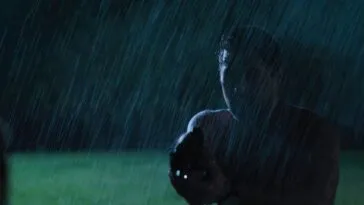 The silouette of a man holding a gun in the rain of WHEN IT RAINS IN LA