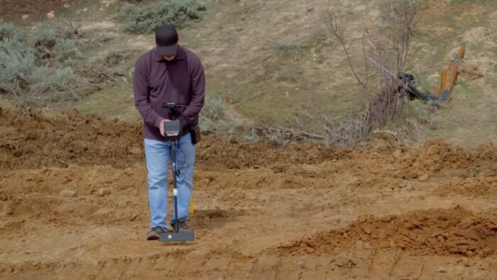 James Keenan uses a magnetometer to try and find a new spot to dig
