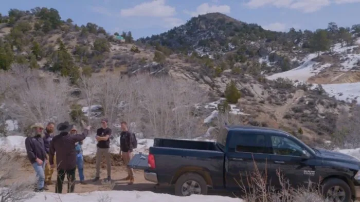 Duane's team and Stephen Leeah's team stand on Blind Frog Ranch as Stephen tells them what they plan on doing
