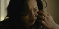 a woman staring at her hand.