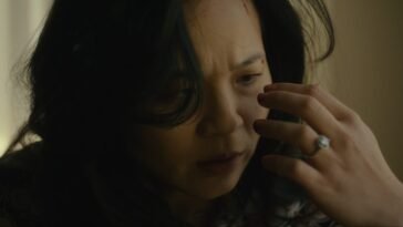 a woman staring at her hand.