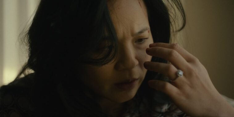 a woman staring at her hand.