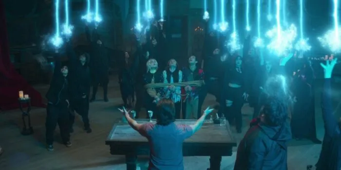 A group of cultists raising their hands to the sky and unleashing light beams