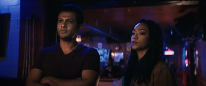 A man and a woman standing beside each other in a bar